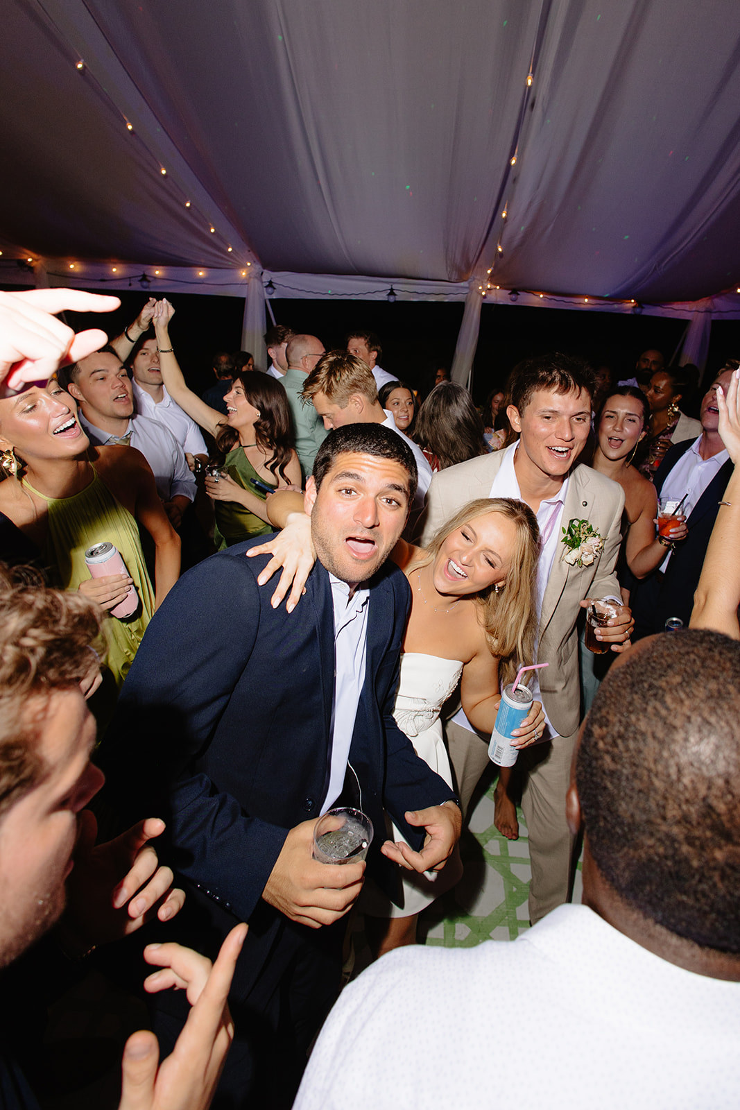 Late-night wedding dance floor full of guests
